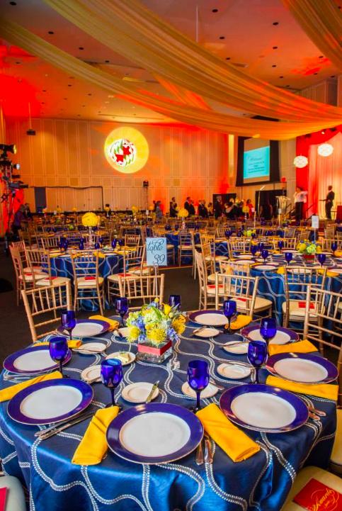 Blue and Gold event with draping fabric on ceiling