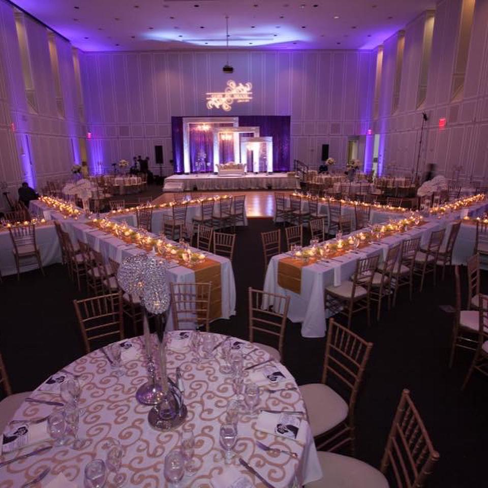 Tables set with candles and florals in X shape