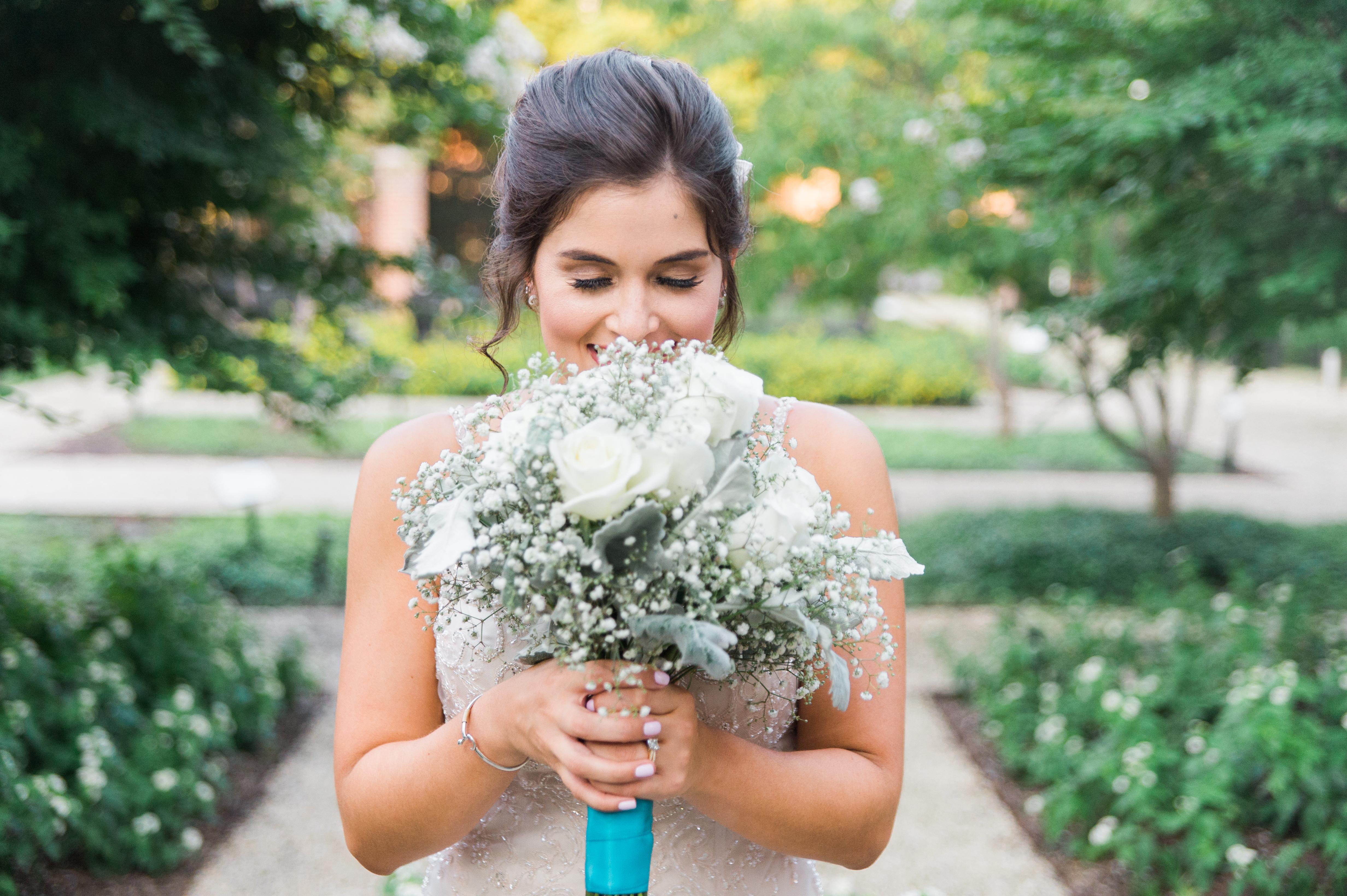 Woman holding bouquet of flowers in garden