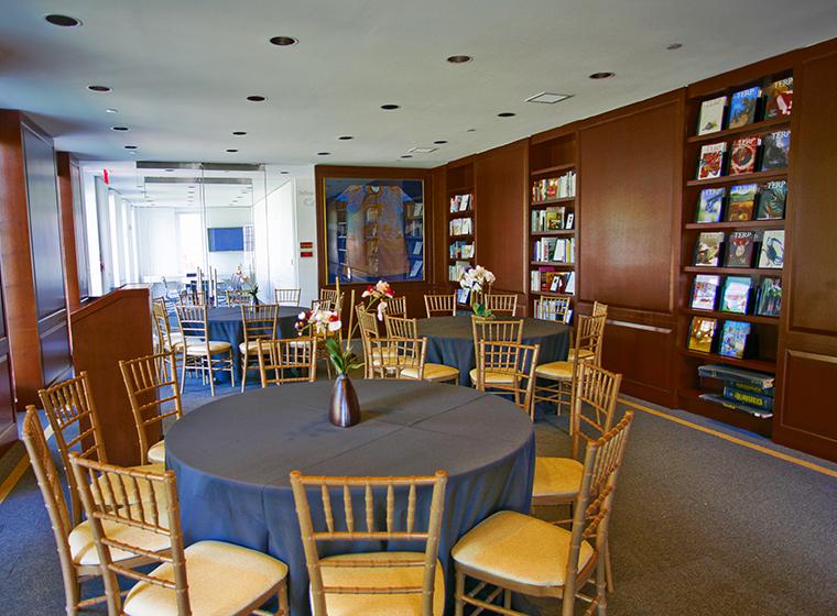 Round tables with black linens and natural chivari chairs