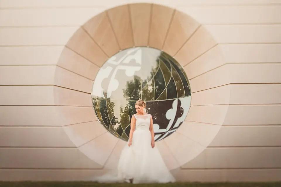 Bride Outside in front of MD Flag Stained Glass Oculus 